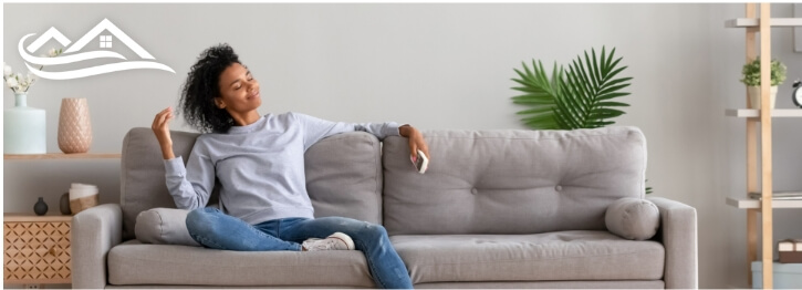 Woman sitting on a couch inside