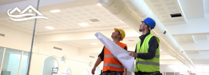 Two technicians inspecting the inside of a building