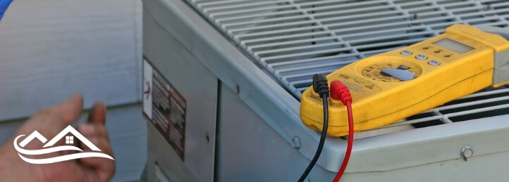 Technician checking the voltage of an AC unit